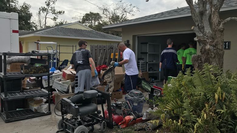 Shane Molyneaux and Jim Perry help clear out Florida home damaged by Hurricane Irma
