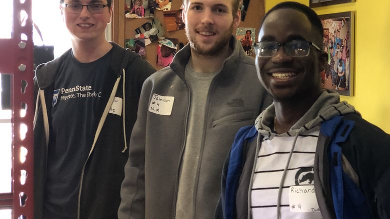 three students smiling 