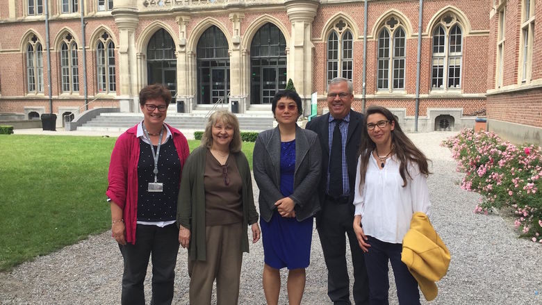 Five professors from Catholic University and Penn State stand in front of a building in France.
