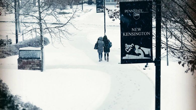Students make their way through the snow to the Penn State New Kensington Athletic Center.