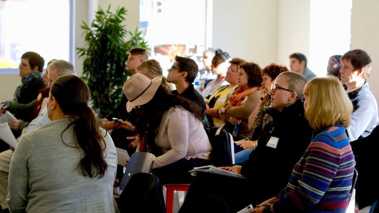 Participants at an entrepreneurial workshop look on