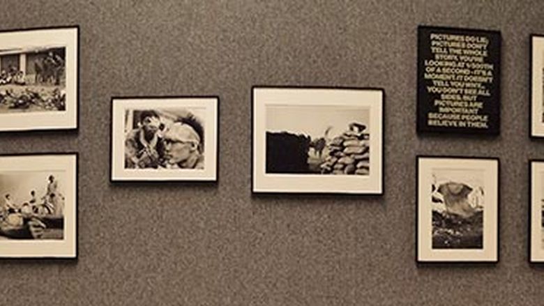 grey art gallery wall full of black and white photos 