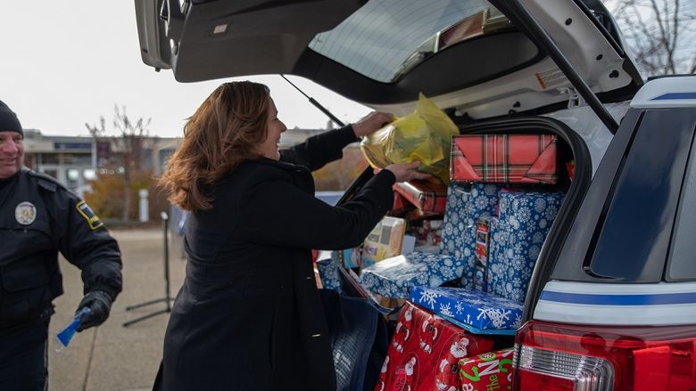 Woman places gifts in car