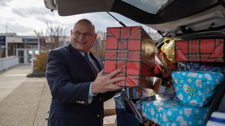 Man puts wrapped gift in car