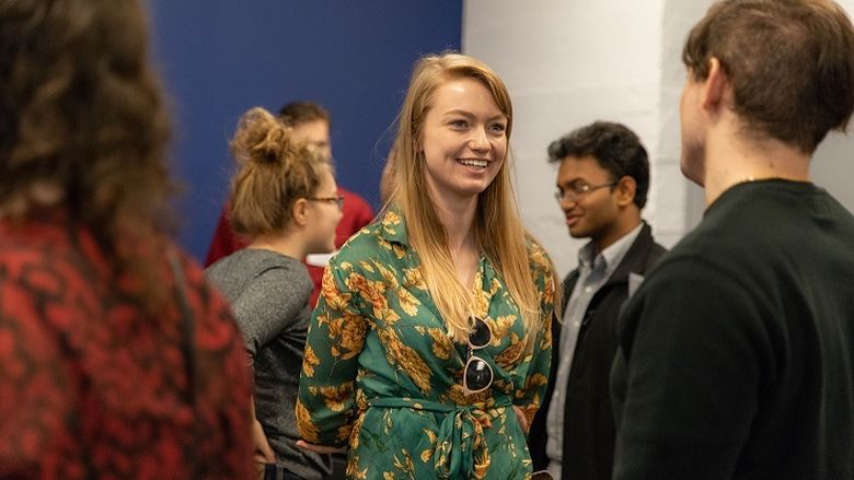 Female student speaks to another student