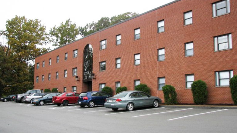 The parking lot and exterior of the Nittany Highlands Apartments