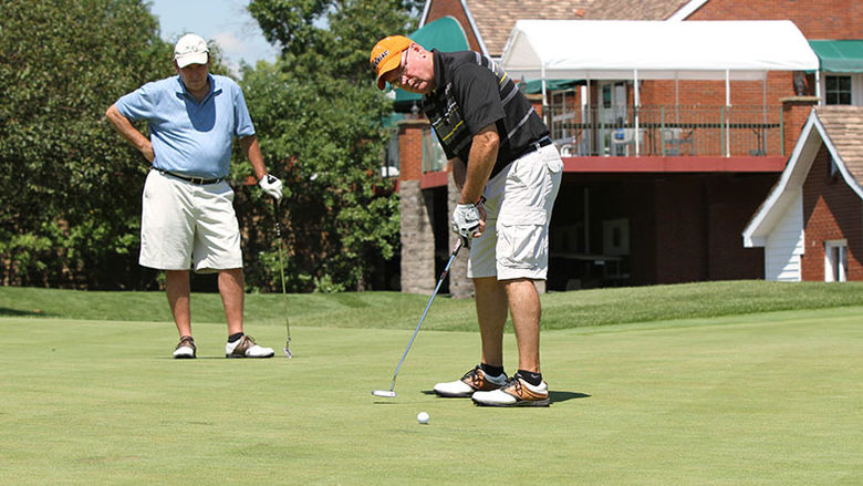 Two golfers standing on the green