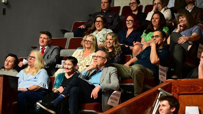 Audience members smile and laugh during the Celebration of Excellence event at Penn State New Kensington, seated in the campus theatre’s reserved section.