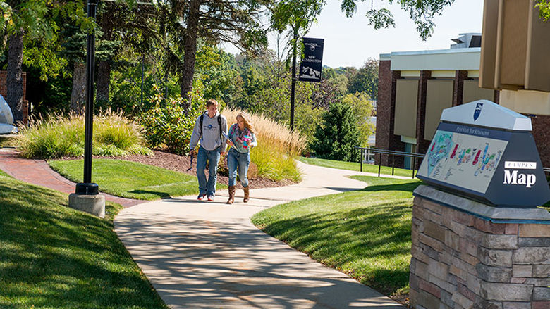 Two students walking on the campus grounds