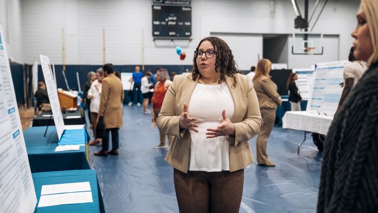 Student stands at research fair
