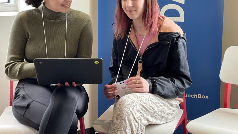 Two students looking at a computer.