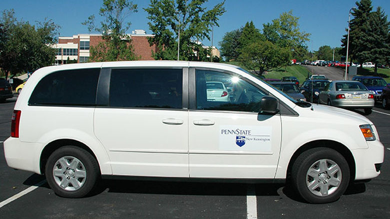 Campus shuttle in a parking lot