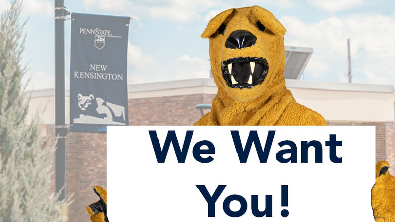 Nittany Lion mascot holds sign reading, "We Want You!"