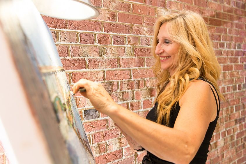 Woman painting on canvas