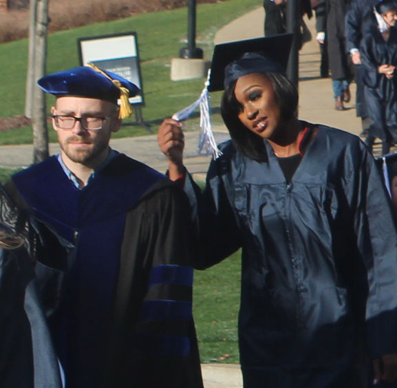 Faculty and student at commencement faculty and student
