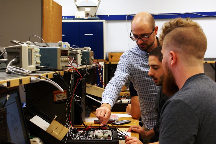 EMET professor and students in lab