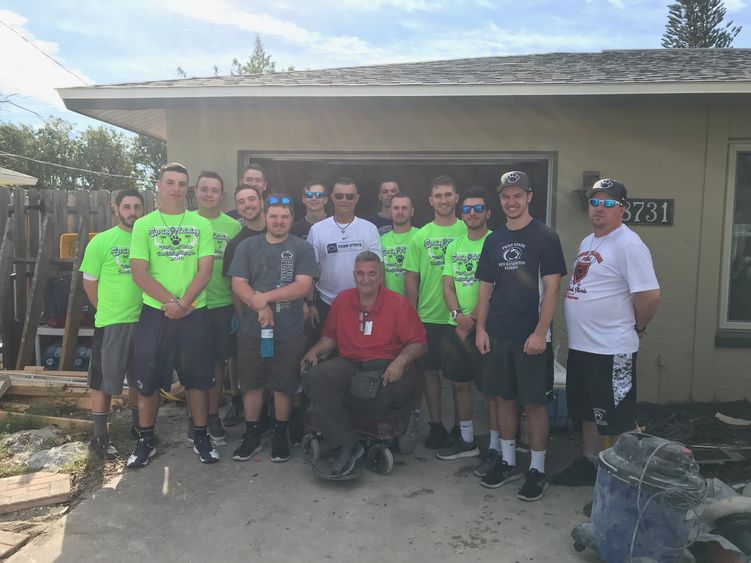 New Kensington baseball team breaks for a photo with Ft. Myers, Florida Resident