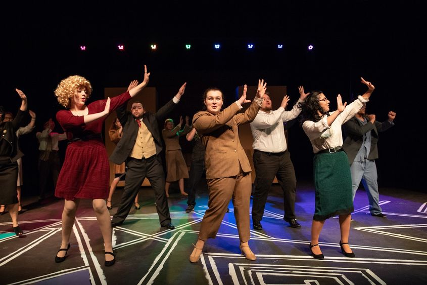 Musical cast members singing and dancing Musical cast members singing and dancing