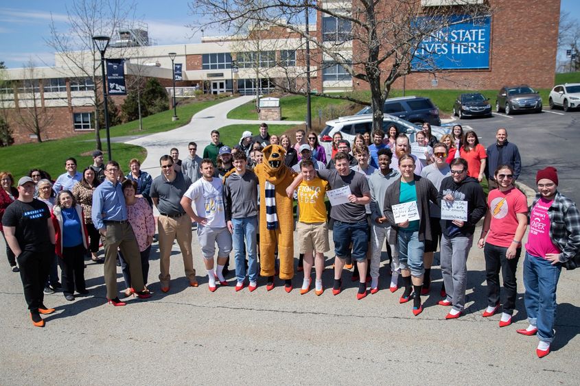 Group of men and women stand for group photo Group of men and women stand for group photo