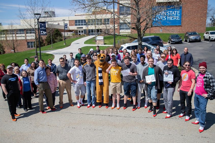 Group of men and women stand for group photo