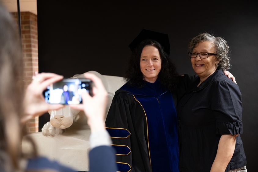 Two women stand together for photo