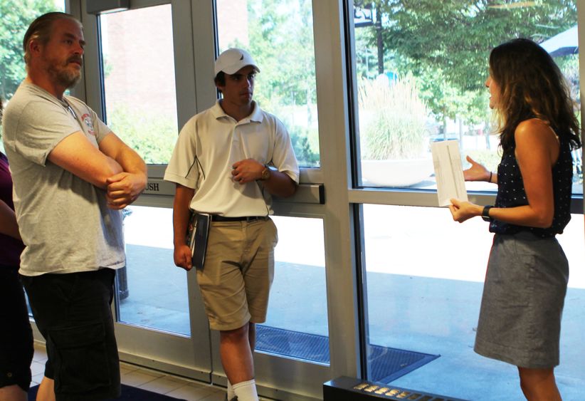 Campus staff member with prospective student and family at campus Staff and prospective student