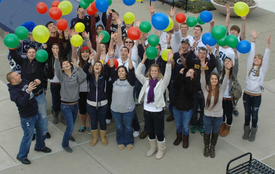 Students cheering outside of campus Students cheer