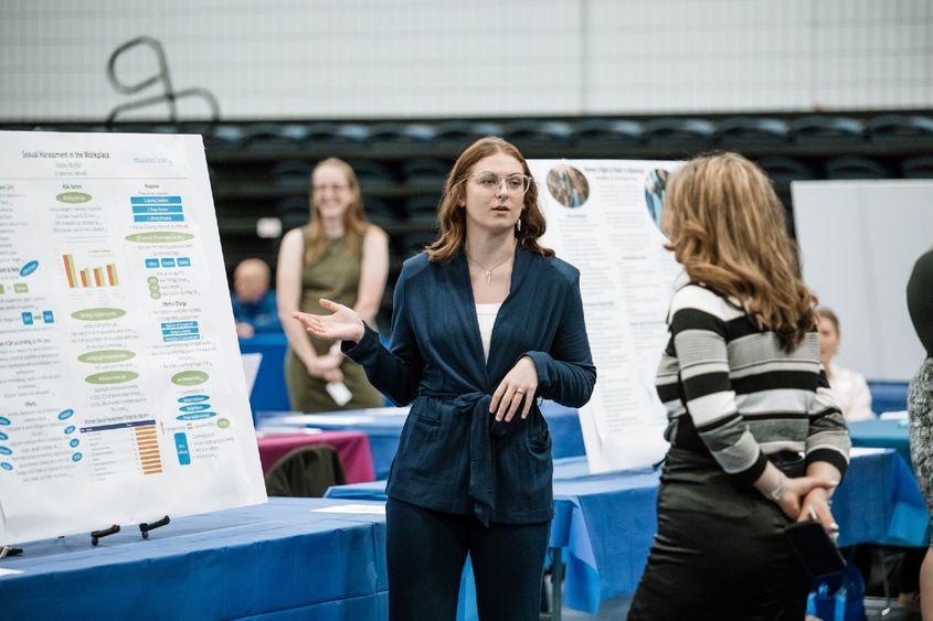 Student presents her research project at annual exposition