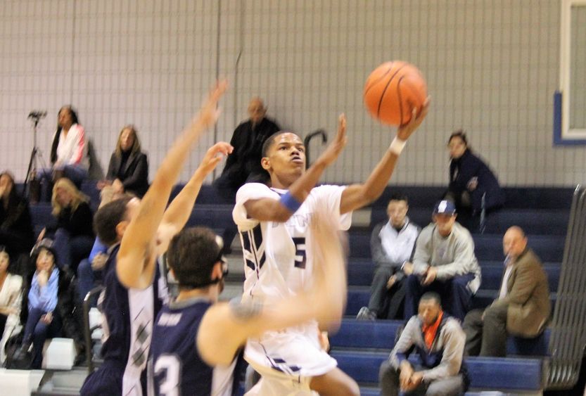 Basketball players Dorian Broadwater, senior at New Kensington, scores 1,000th point