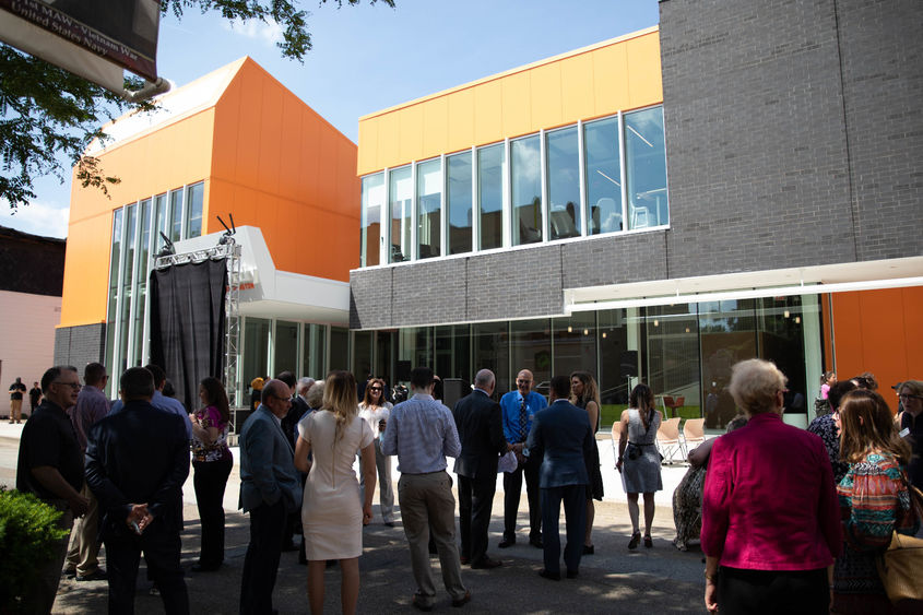 People stand outside building before event